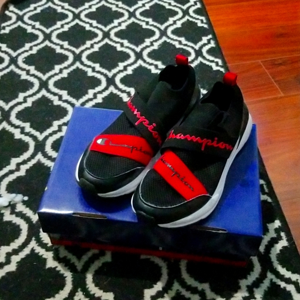 Red black and white Champion tennis shoes.
